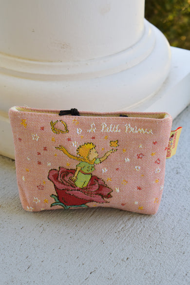 Small pink fabric  makeup, toiletries pouch with a prince design on a white surface. little prince pouch le petit prince gift