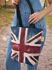 Person holding a tote bag with a Union Jack design outdoors. Union Jack Britain London England Aesthetic Europe Tote Bag Taylor Swift