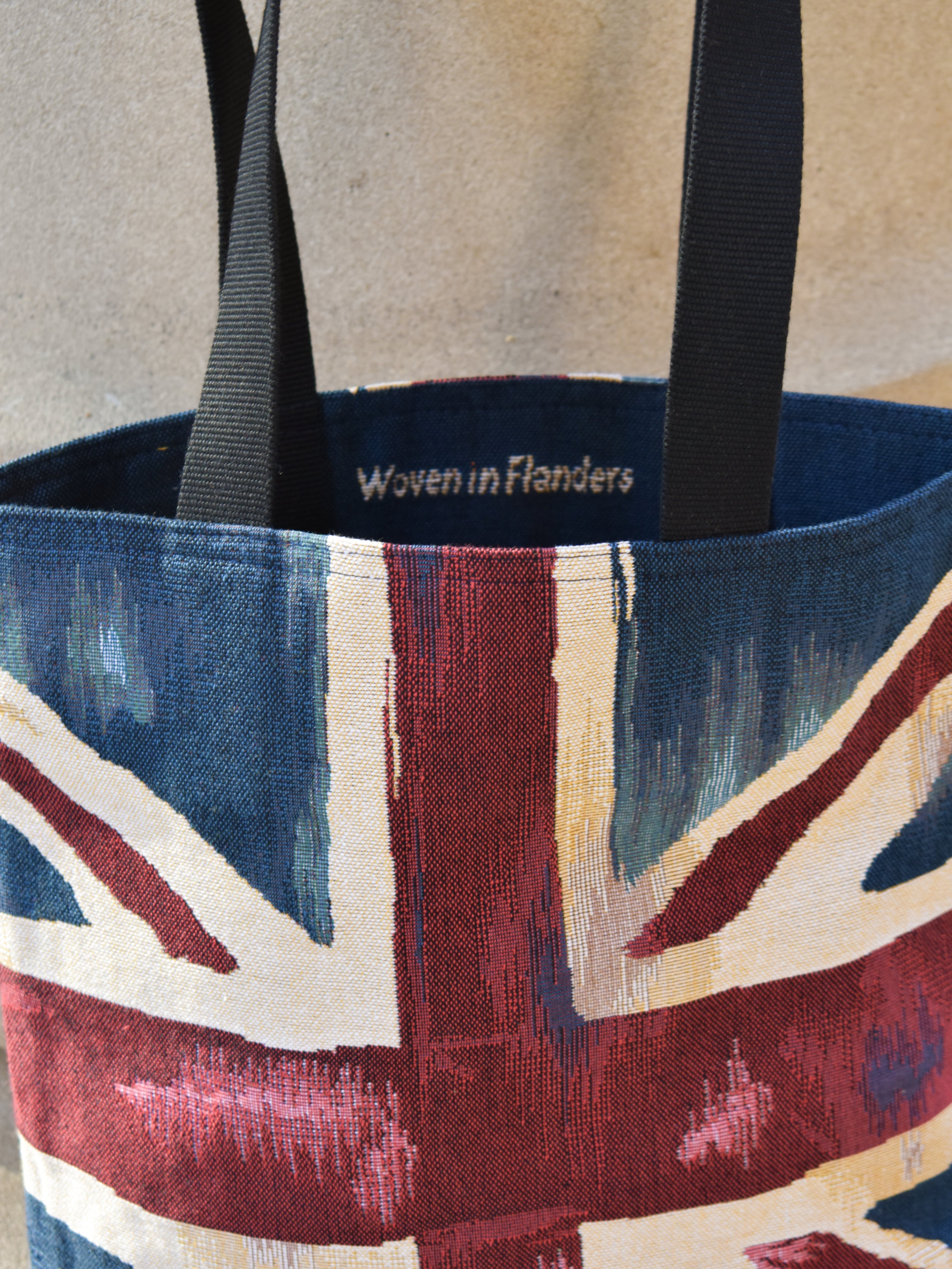 Tote bag with Union Jack design and 'Woven in Flanders' branding.