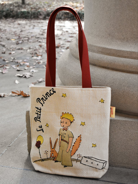 Tote bag with 'Le Petit Prince' design on a stone surface