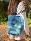 Person wearing a blue tote bag with water lily design outdoors